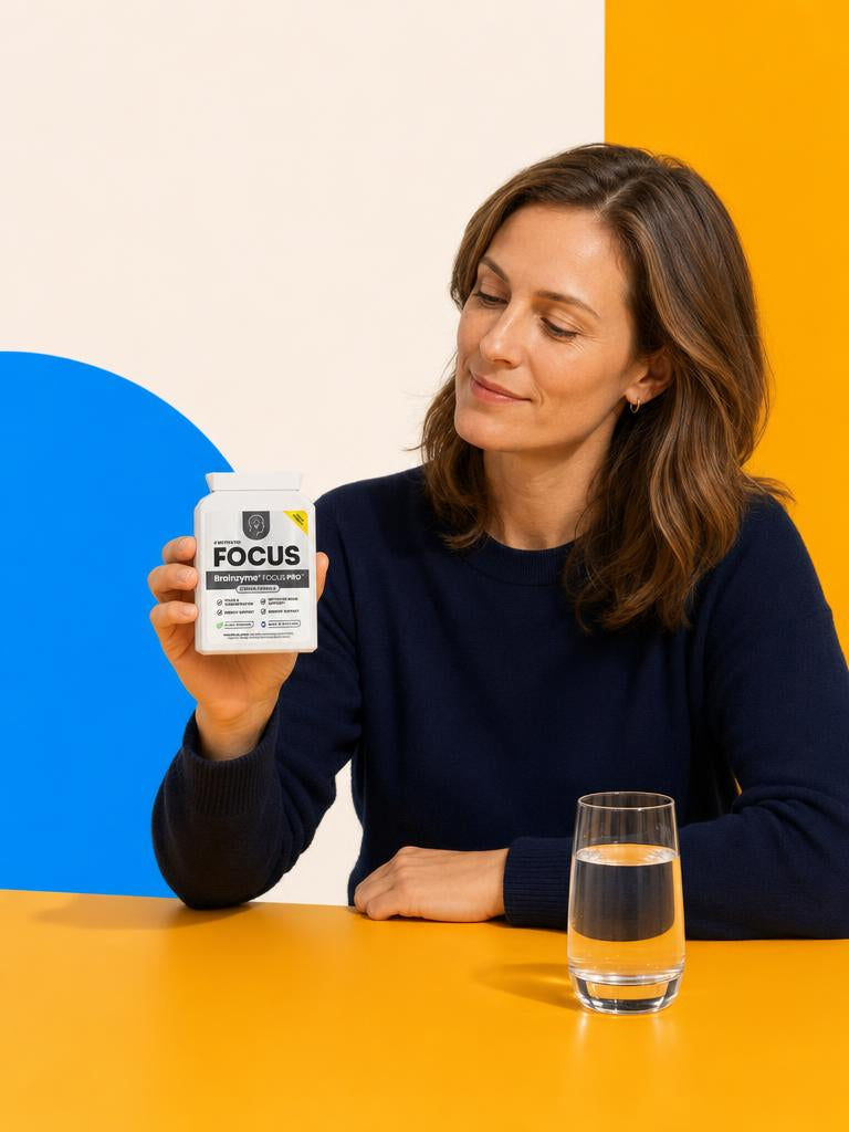 A woman looking at Brainzyme FOCUS PRO at the yellow table